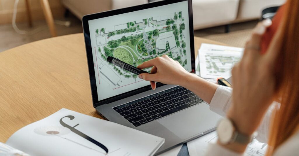 Architect reviewing landscape design on laptop, enhancing architectural projects from home office.